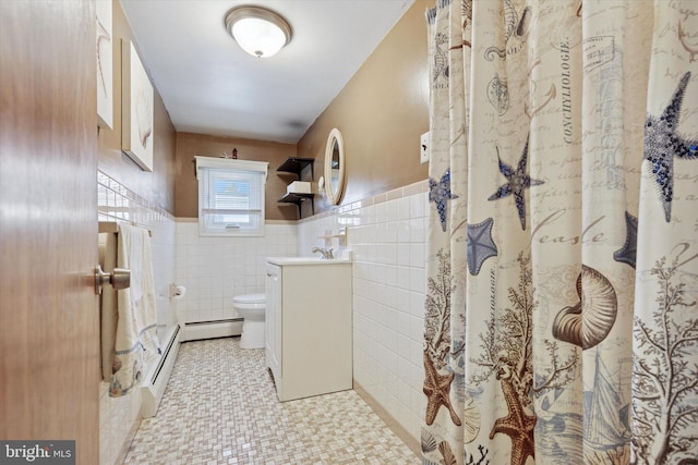 full bath with tile walls, a wainscoted wall, toilet, vanity, and a baseboard radiator