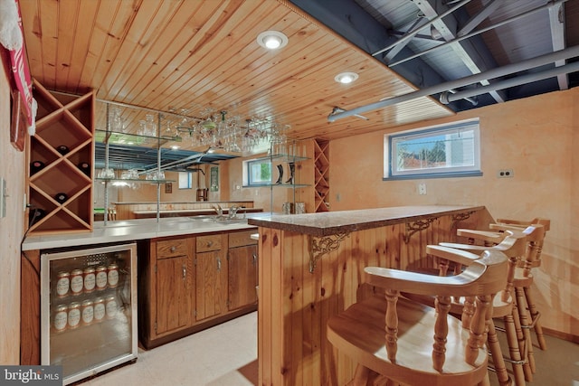 bar featuring wine cooler, light floors, indoor wet bar, and wood ceiling