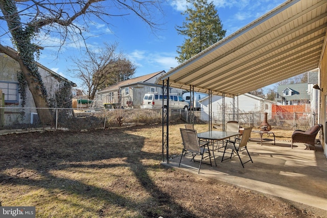 view of yard with a patio area, outdoor dining area, and fence