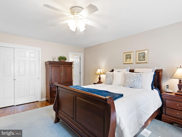 bedroom with a closet, ceiling fan, and wood finished floors