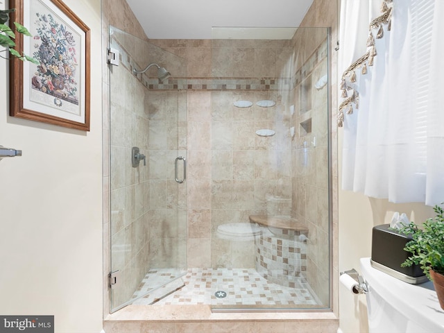 full bathroom with a shower stall and toilet