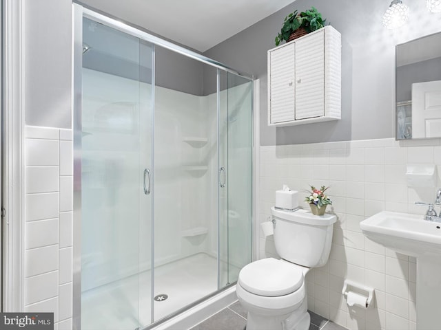 full bathroom featuring a stall shower, tile walls, and toilet