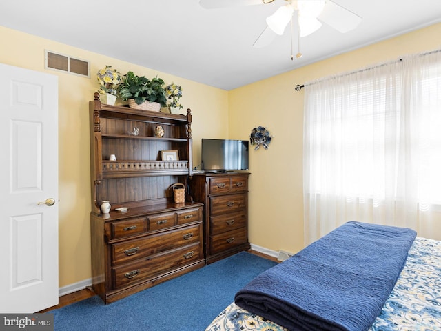 bedroom with a ceiling fan, visible vents, and baseboards