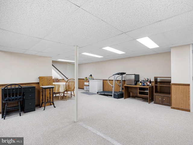 carpeted office with a drop ceiling and wainscoting