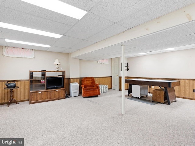 finished basement with wood walls, carpet, and wainscoting