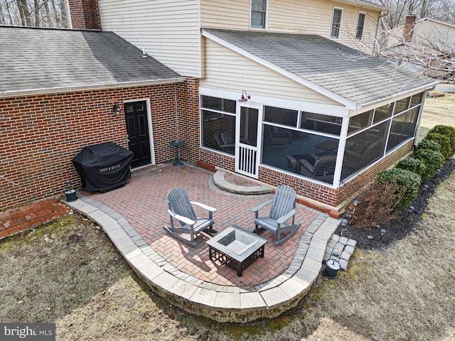 view of patio / terrace featuring a sunroom and grilling area