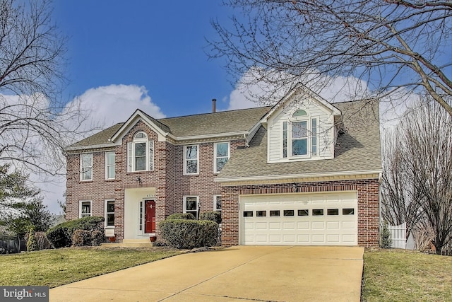 view of front of house with brick siding, driveway, a front lawn, and roof with shingles