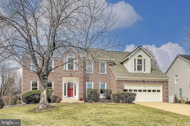 view of front of home featuring brick siding, a shingled roof, concrete driveway, a front yard, and a garage