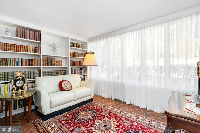 living area featuring brick floor