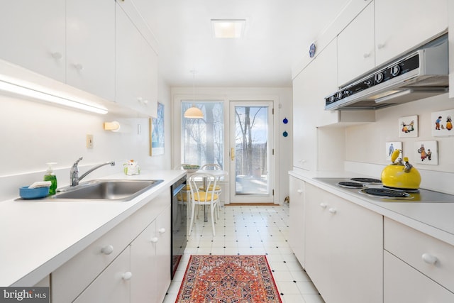 kitchen with light floors, light countertops, white cabinets, a sink, and under cabinet range hood