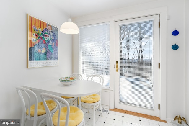 dining space featuring light floors and visible vents