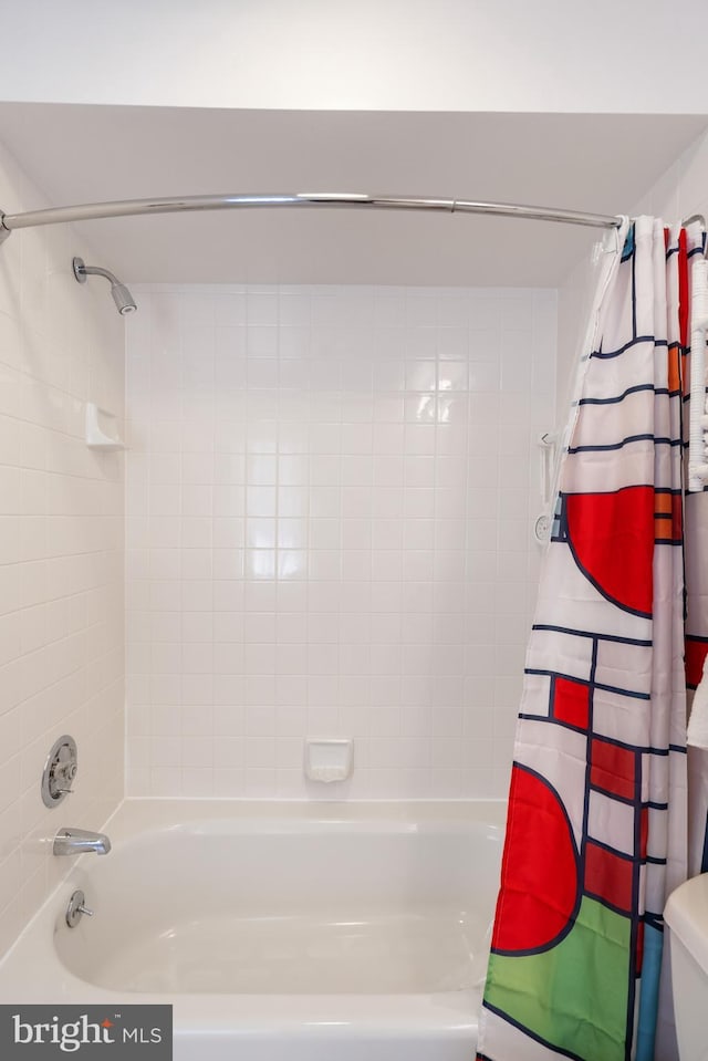 full bath with toilet and shower / bath combo with shower curtain