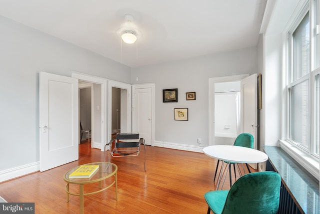 living area featuring wood finished floors and baseboards