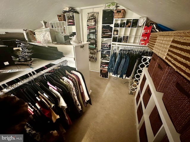 walk in closet with carpet flooring and lofted ceiling