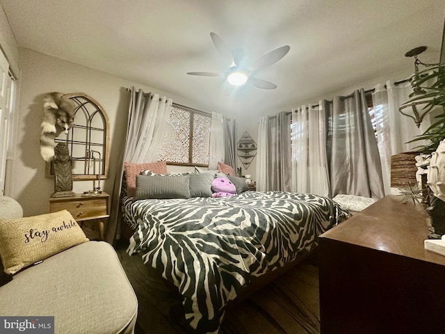 bedroom with ceiling fan and wood finished floors