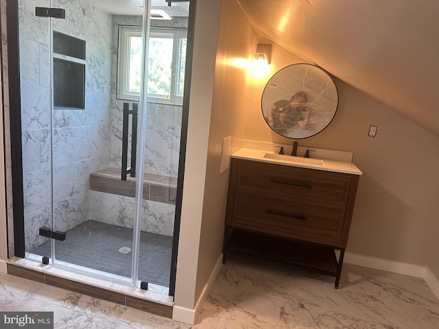 bathroom featuring baseboards, vaulted ceiling, a stall shower, marble finish floor, and vanity