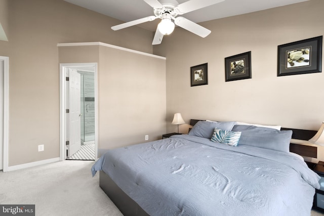 bedroom featuring a ceiling fan, ensuite bath, baseboards, and carpet flooring