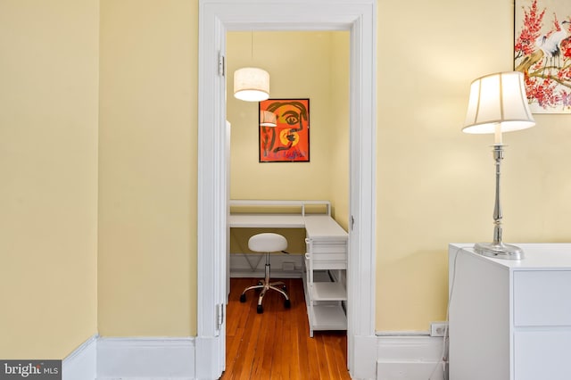 interior space with baseboards and wood finished floors