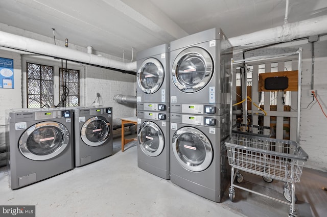 shared laundry area with stacked washer and dryer and washer and clothes dryer