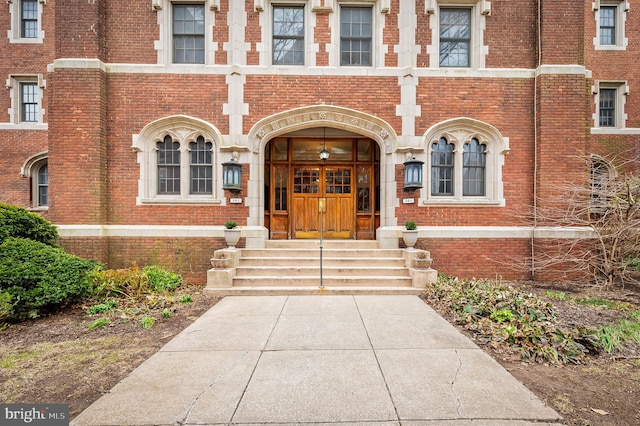 view of exterior entry with french doors and brick siding