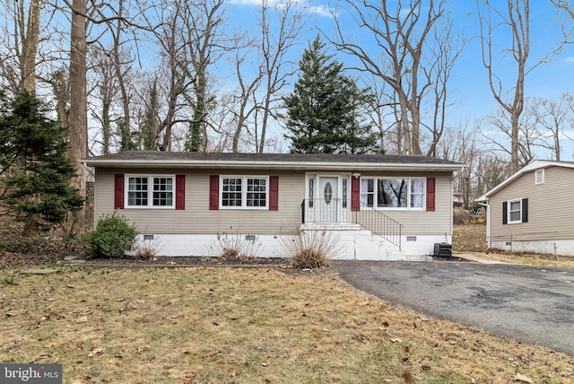 ranch-style home featuring driveway, crawl space, and central air condition unit