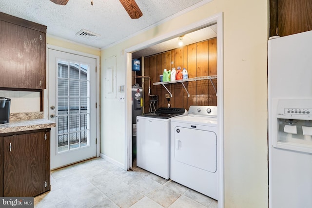 clothes washing area featuring laundry area, visible vents, ceiling fan, a textured ceiling, and washer and dryer