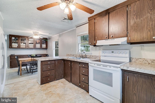 kitchen with white electric range oven, visible vents, light countertops, under cabinet range hood, and a sink