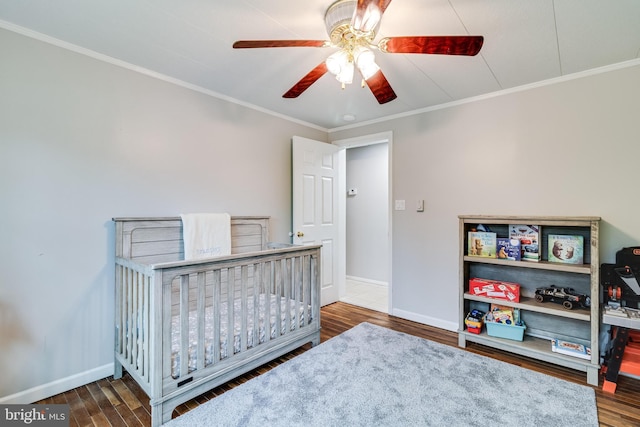 bedroom with crown molding, ceiling fan, wood finished floors, and baseboards