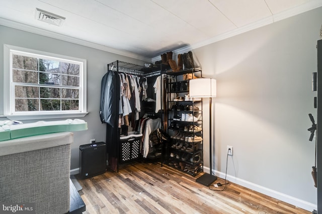 walk in closet featuring visible vents and wood finished floors