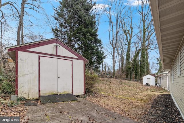 view of shed featuring fence