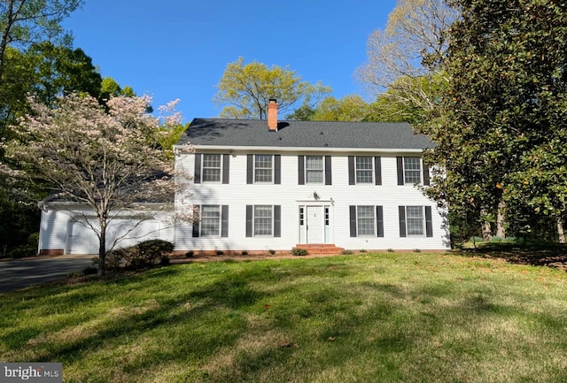 13086 Langley Rd, Bryantown, MD 20617 - colonial inspired home featuring a chimney, aphalt driveway, and a front yard