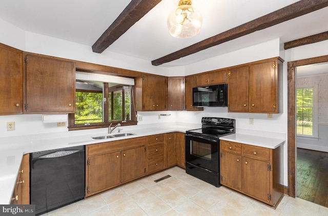 13086 Langley Rd, Bryantown, MD 20617 - kitchen with a sink, beam ceiling, black appliances, and light countertops