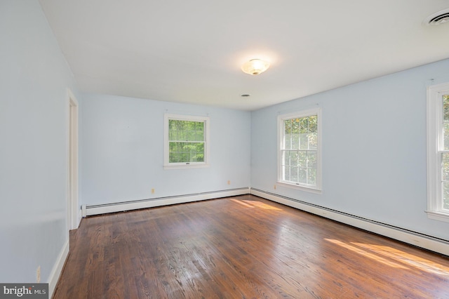 13086 Langley Rd, Bryantown, MD 20617 - empty room featuring visible vents, baseboard heating, wood finished floors, baseboards, and a baseboard heating unit