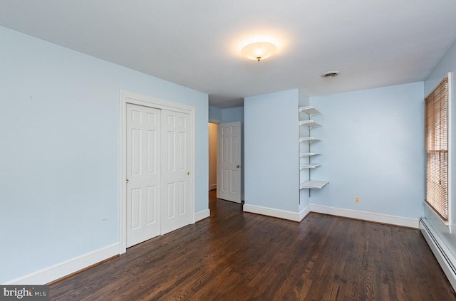 13086 Langley Rd, Bryantown, MD 20617 - unfurnished bedroom featuring baseboards, a baseboard radiator, and dark wood finished floors