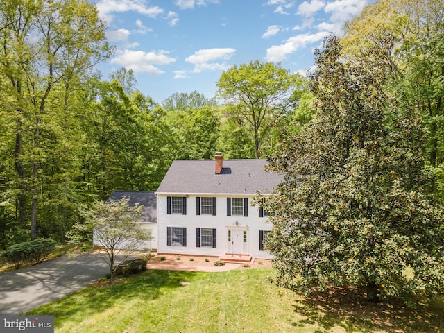 13086 Langley Rd, Bryantown, MD 20617 - view of front of home featuring roof with shingles, a chimney, driveway, and a front yard