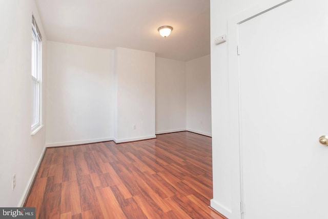 unfurnished room featuring wood finished floors and baseboards