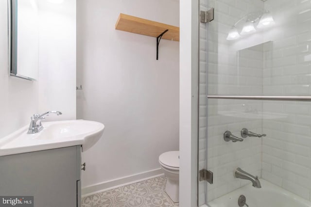 full bath featuring baseboards, toilet, vanity, tile patterned flooring, and shower / bathtub combination