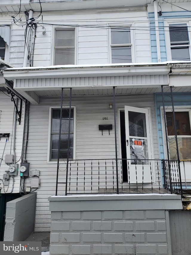 view of exterior entry with covered porch