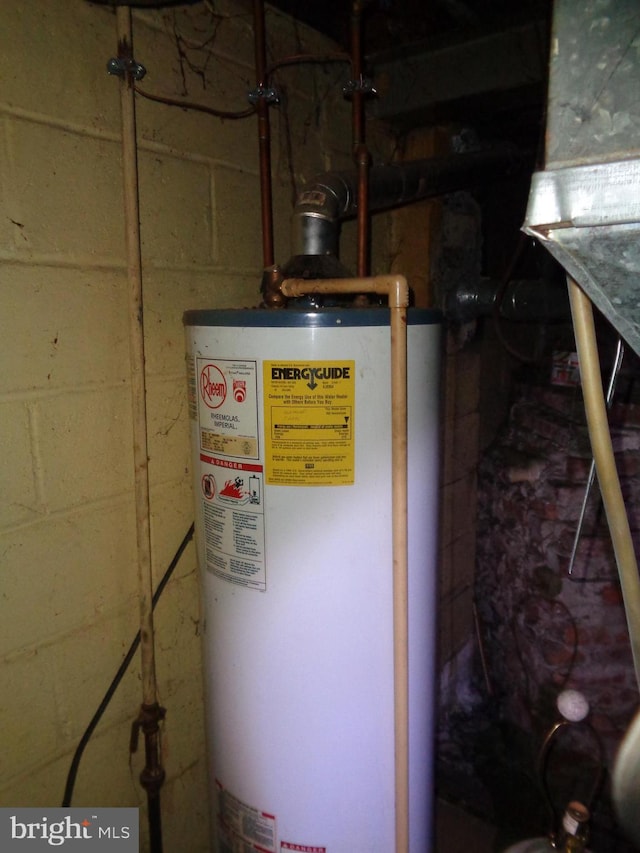 utility room featuring water heater