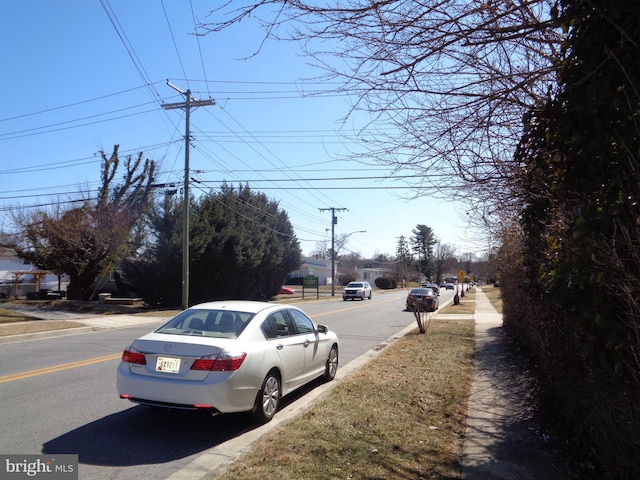 view of street featuring street lighting, curbs, and sidewalks