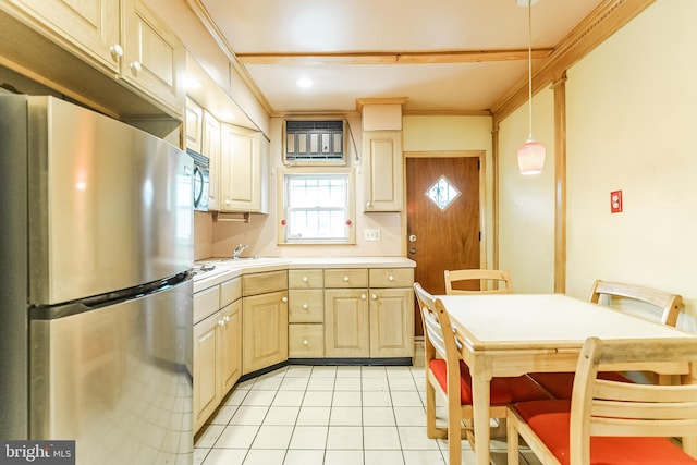 kitchen with light tile patterned floors, crown molding, light countertops, appliances with stainless steel finishes, and pendant lighting