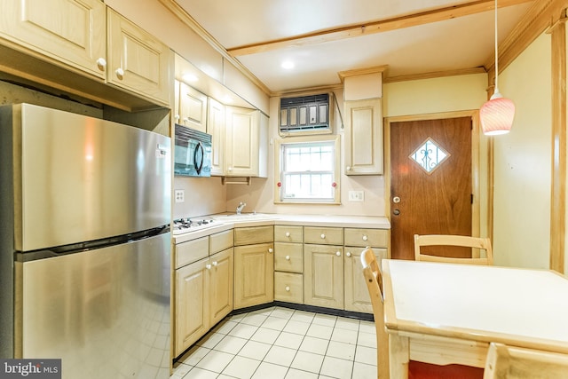 kitchen featuring white cooktop, light countertops, ornamental molding, and freestanding refrigerator