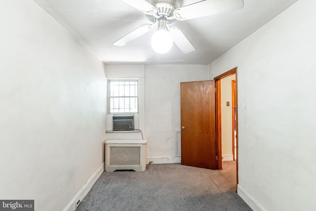 interior space featuring cooling unit, a ceiling fan, and baseboards