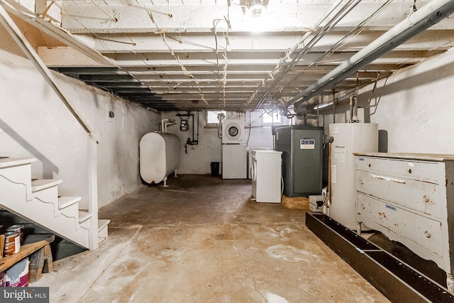 basement with refrigerator, water heater, stairs, heating fuel, and washer / dryer