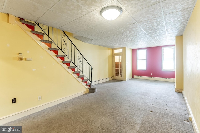 interior space with stairs, baseboards, baseboard heating, and carpet flooring