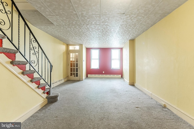 interior space with carpet floors, stairway, baseboard heating, and baseboards