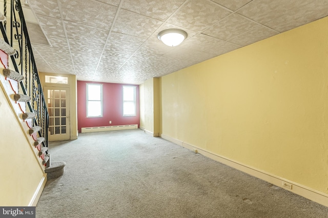 interior space featuring carpet floors, baseboards, stairs, and a baseboard heating unit