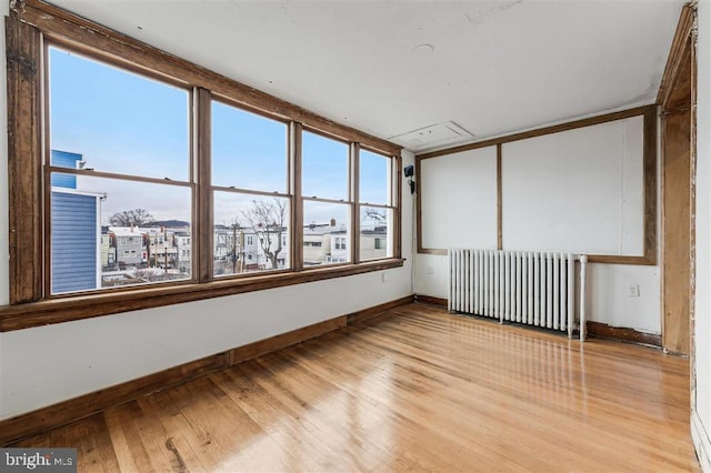 unfurnished sunroom featuring radiator heating unit