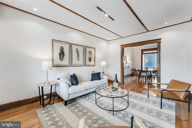 living room with light wood finished floors, baseboards, and recessed lighting