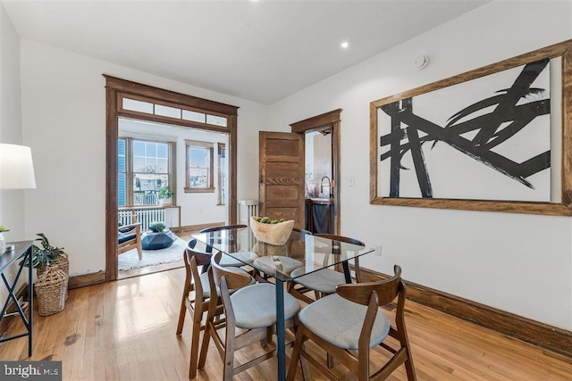 dining room with light wood-type flooring and baseboards